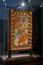 an antique religious catholic icon in a museum behind glass in italy