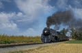 Antique Restored Steam Engine Approaching on Some Old Rail Road Tracks Royalty Free Stock Photo