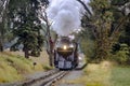 Antique Restored Steam Engine Approaching on Some Old Rail Road Tracks Royalty Free Stock Photo