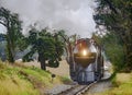 Antique Restored Steam Engine Approaching on Some Old Rail Road Tracks Royalty Free Stock Photo