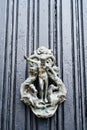 Antique ring door handle with antique male figure and horses.