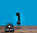 Old rotary dial telephone on wooden desk with copy space Royalty Free Stock Photo