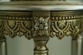 Antique round metal bronze table detail decorated with abstract patterns, close-up view