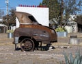 Antique rusted out half automobile on an empty lot in Marfa, Texas.