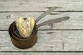 Antique rusty copper pots on wooden background