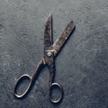 Antique rusty tailor scissors close-up on gray textured background, stylized