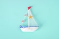 Antique sail boat Toy model with rope and seashell on white and Royalty Free Stock Photo