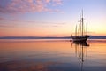 antique sailboat anchored in a serene bay at sunset Royalty Free Stock Photo