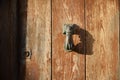 Antique Sardinian wooden door with rusty brass knocker Royalty Free Stock Photo