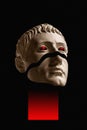 Antique sculpture of human face surreal collage in pop art style. Modern image with cut details of statue head. Red eyes