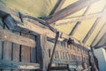 Antique scythe hanging on the wall in the barn.Old farm tools. Royalty Free Stock Photo