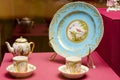 An antique set of ceramic teapots, cups, saucers on a wooden table. Royalty Free Stock Photo