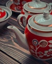 An antique set of ceramic teapots, cups, saucers on a wooden table. Royalty Free Stock Photo