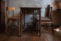 Antique set of old table and chair interior with vintage grunge white wall texture decoration with blank space for text. Royalty Free Stock Photo