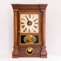 Antique Seth Thomas cherry wood mantle clock with reverse painting and display window for pendulum.