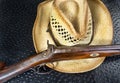 Antique Shotgun and Straw Hat.