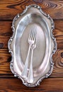 Antique silver cutlery on a wooden table. forks