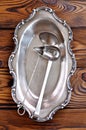 Antique silver cutlery on a wooden table. ladles for canned fruits and vegetables.
