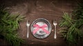 Antique silver plate, spoon, fork and pine branches on a dark wooden background Royalty Free Stock Photo