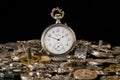 Antique silver pocket watch among clockwork parts on black isolated studio background. Gears, cogwheels, old metal Royalty Free Stock Photo