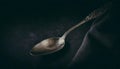 Antique Silver Spoon on Dark Moody Background with Elegant Decorative Handle Royalty Free Stock Photo