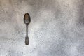 Antique silver spoon on gray concrete style.