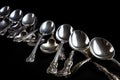 antique silver spoons arranged in row on black background Royalty Free Stock Photo