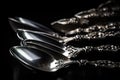 antique silver spoons on black background, with glare Royalty Free Stock Photo