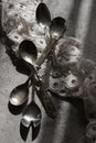 Antique silver spoons with handmade embroidery napkin Royalty Free Stock Photo