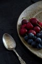 Antique Silver Utensil with Fresh Blueberries and Red Cherries on Dark Background