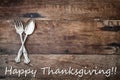 Antique Silverware and Happy Thanksgiving text over Wooden Background