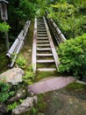 Antique small stone steps with fence leading up to the mountain