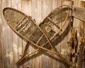 Antique Snow Shoes Hanging on Wooden Wall