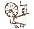 Antique spinning wheel with yarn and bobbins isolated on white