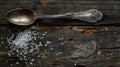 An antique spoon with salt on wood Royalty Free Stock Photo