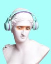 Antique statue bust with human eye photo elements expressing shock, wearing headphones on blue background. Modern design