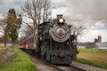 Antique Steam Passenger Train Approaching on a Single Track Blowing Smoke Royalty Free Stock Photo