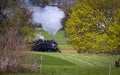 Antique Steam Passenger Train Approaching on a Single Track Blowing Smoke Royalty Free Stock Photo