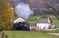 Antique Steam Passenger Train Approaching on a Single Track Blowing Smoke Royalty Free Stock Photo