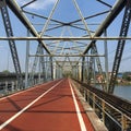 Antique steel bridge across river against sky