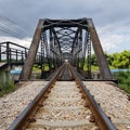 Antique steel railway bridge against sky