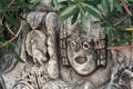 Antique stone-cut mask among vegetation in the ruins of the ancient city of Myra, Turkey Royalty Free Stock Photo