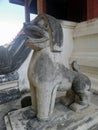 Antique stone lion guarding the temple entrance