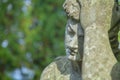 Antique stone statue of sad man on tomb as a symbol of depression, pain and sorrow Royalty Free Stock Photo