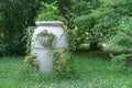 Antique stone vase with garden flowers in a summer park Royalty Free Stock Photo