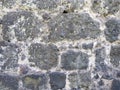 Antique stone wall. Background from a gray stone. The architecture of antiquity. Bricks of the Middle Ages. Remains of the castle Royalty Free Stock Photo