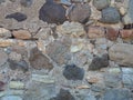 Antique stone wall. Background from a gray stone. The architecture of antiquity. Bricks of the Middle Ages. Remains of the castle