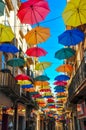 Antique street decorated with bright umbrellas.