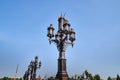 Antique street lamp and blue sky on background. Large street lamp with five lamps Royalty Free Stock Photo