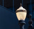 Antique street lamp glowing at dusk Royalty Free Stock Photo